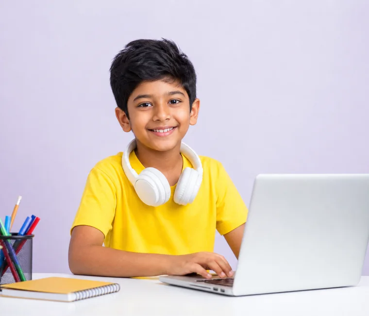 Happy young student learning with a laptop and headphones in skillgy foundation classes
